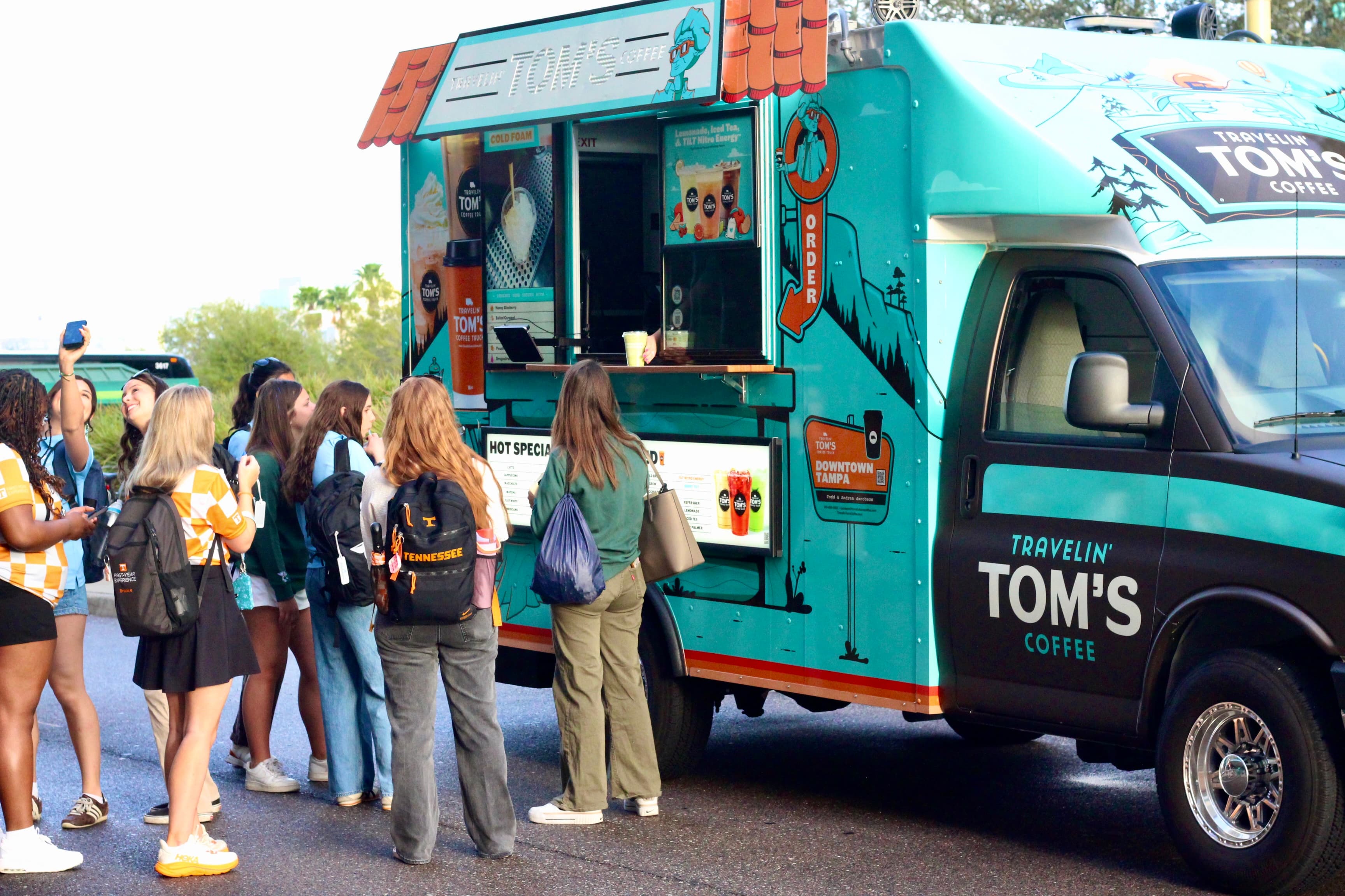 College students placing orders at the Travelin' Tom's Coffee Truck on campus